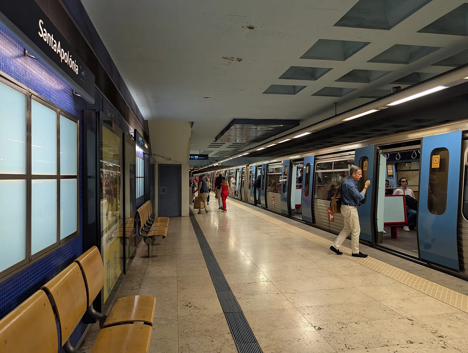רציף תחנת המטרו סנטה אפולוניה בליסבון, פורטוגל, עם נוסעים עולים לרכבת, מקום שבו כדאי לשמור על חפצי הערך מפני כייסים
